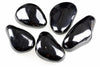 Five polished, dark black stones with a smooth, glossy surface arranged on a white background.
