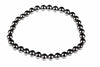 A bracelet made of round, dark metallic beads arranged in a circle on a white background.