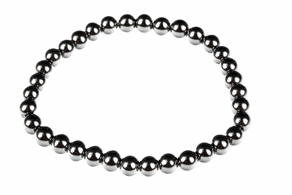 A bracelet made of round, dark metallic beads arranged in a circle on a white background.