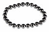 A bracelet made of round, dark metallic beads with a silver-toned finish arranged in a circle on a white background.