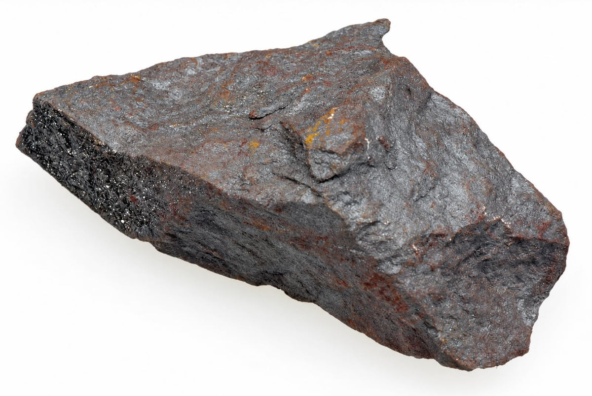 A dark grey, rough-textured rock with brown rust spots and a white background.