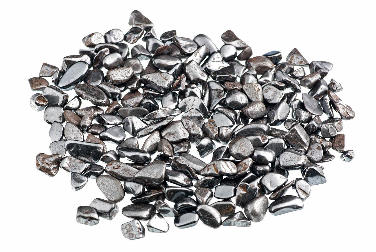 A pile of small, smooth, silver-toned and dark grey polished stones on a white background.