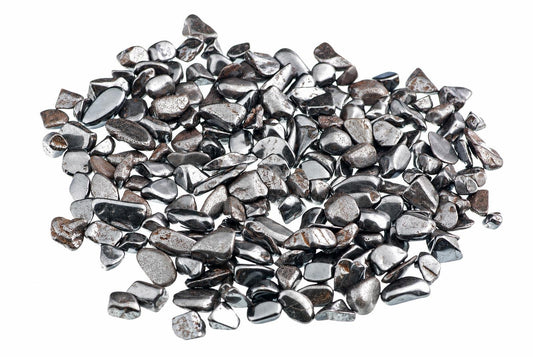 A pile of small, smooth, silver-toned and dark grey polished stones on a white background.