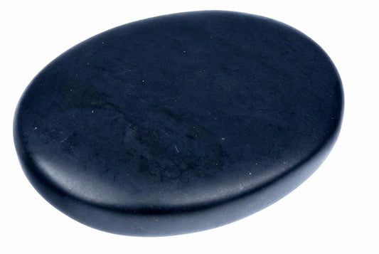 A smooth, dark blue oval massage stone rests on a white surface.