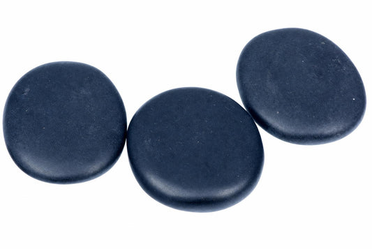 Three smooth, dark blue massage stones arranged on a white surface.