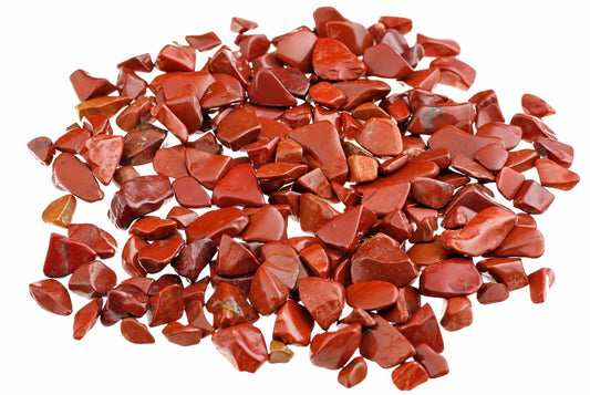 A pile of small, polished red jasper stones on a white background.