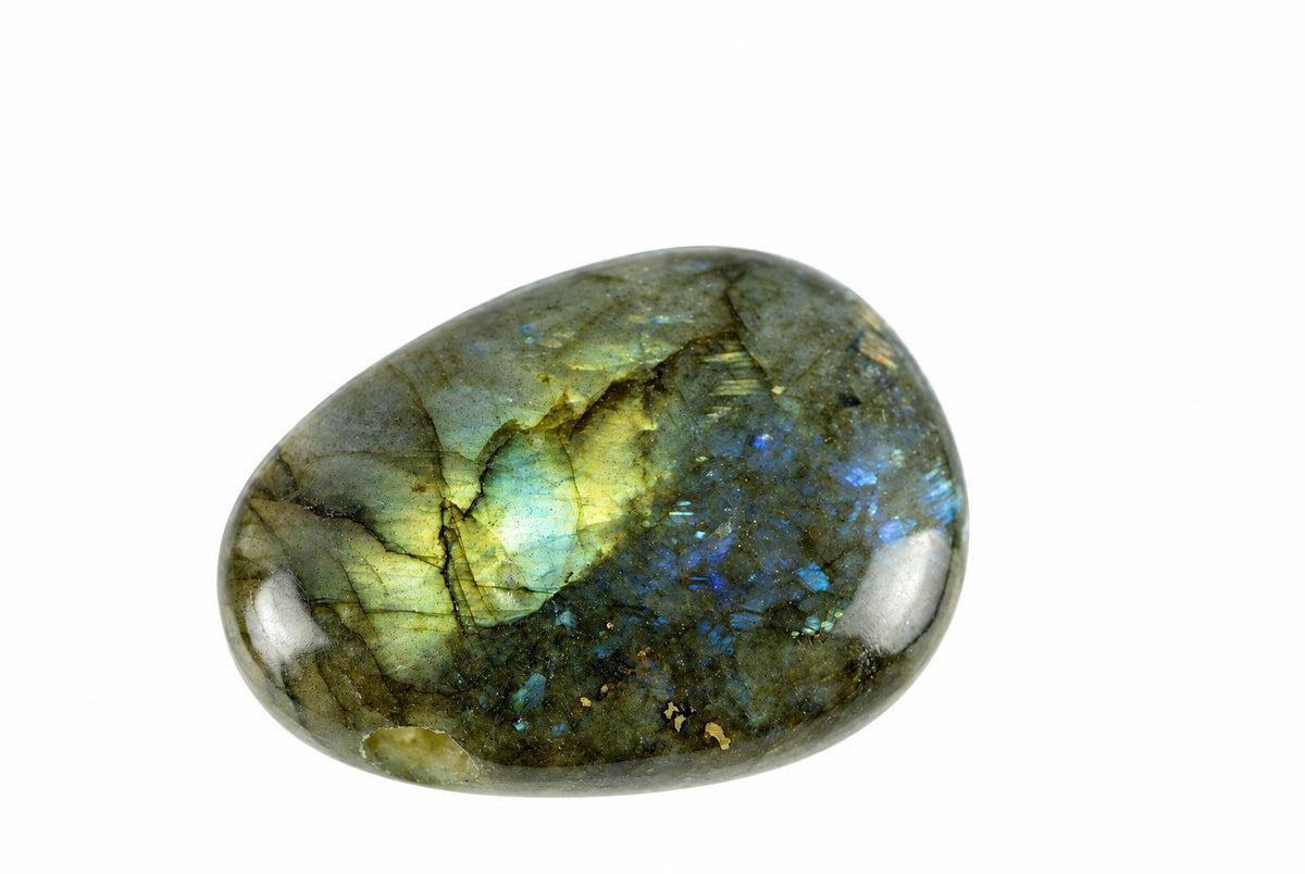 A polished, oval-shaped Labradorite stone with iridescent blue and yellow flashes on a dark grey-green background against white.