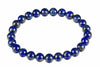 A bracelet of round deep-blue beads with pale patches and gold-toned speckles forms a circle on white.
