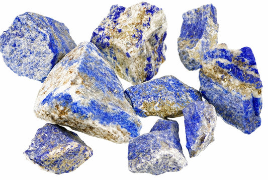 Rough blue-and-white stone pieces with gold-toned flecks are arranged on a white background.
