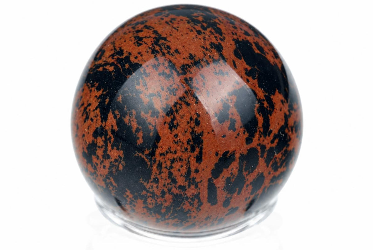 A polished sphere with a glossy surface, featuring a mottled pattern of deep red and black against a white background.