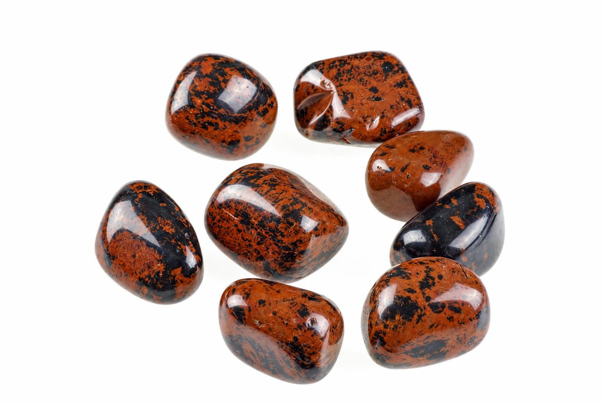 Seven polished tumbled stones with dark brown and black speckled patterns on a white background.