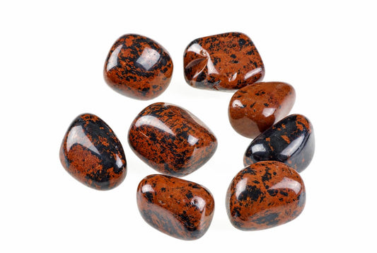 Seven polished tumbled stones with dark brown and black speckled patterns on a white background.