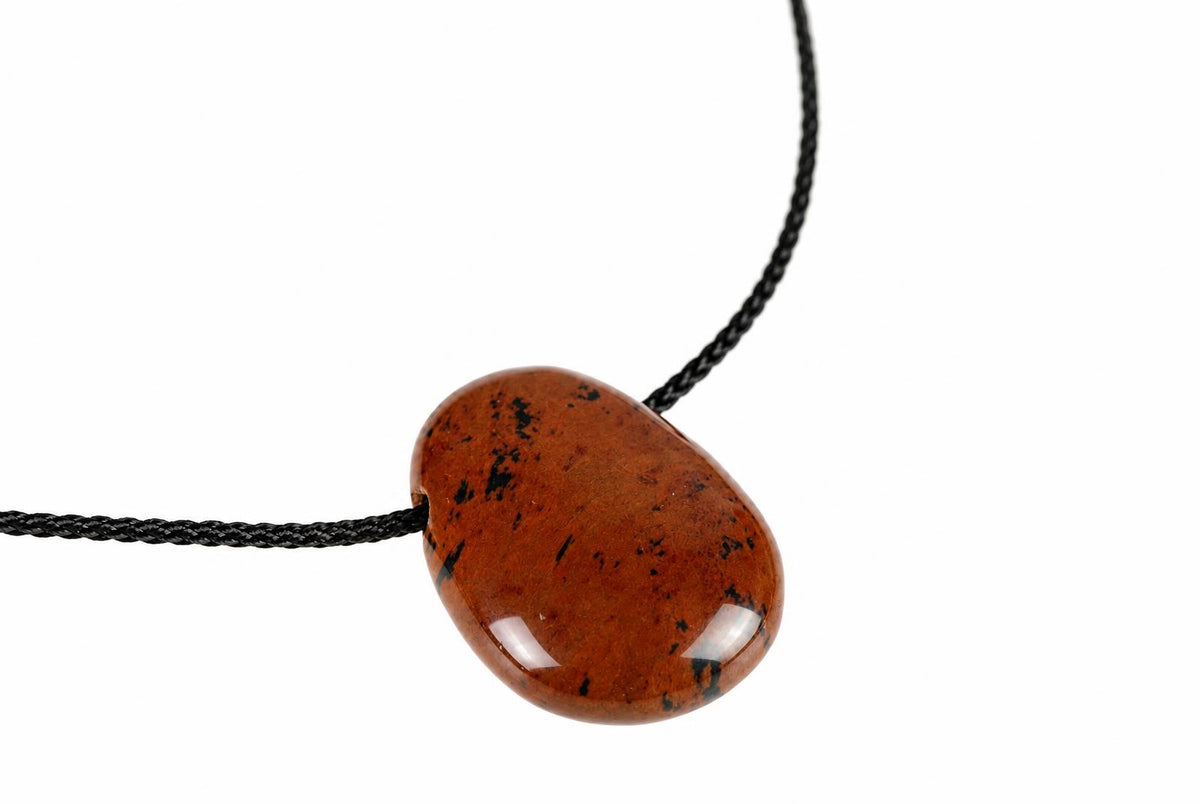A polished, teardrop-shaped pendant with dark brown and black speckles hangs from a black cord against a white background.