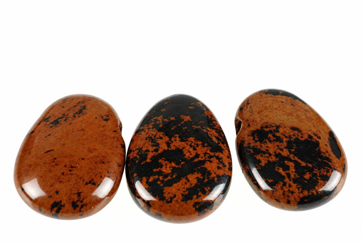 Three polished, teardrop-shaped stones with dark brown and black speckled patterns on a white background.
