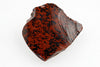A polished, irregular piece of mahogany obsidian with a dark red base and black speckles on a white surface.