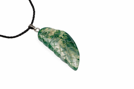 A green and white translucent pendant carved into a wing shape, with an engraved bamboo pattern, on a black cord against a white background.