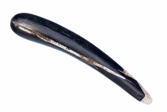 A dark, polished massage stick with a curved shape and lighter streaks along its surface, set against a white background.