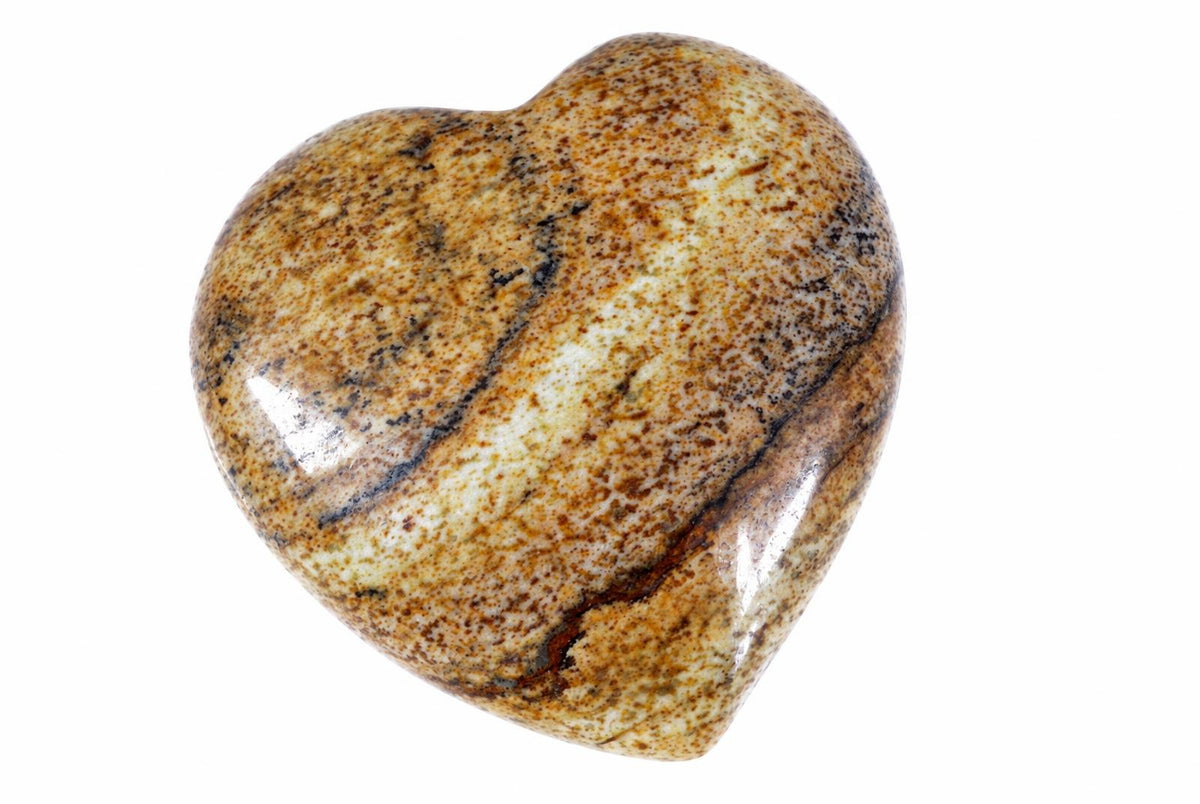 A polished heart-shaped stone with a speckled pattern of brown, black and cream on a white background.