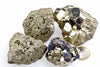 Four metallic gold-toned mineral clusters with angular faces and dark patches rest beside a coin on white.