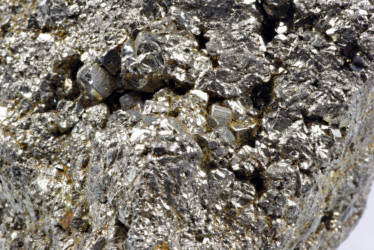 A close-up view of a rough, metallic mineral specimen with silver-toned crystals and dark grey surfaces.
