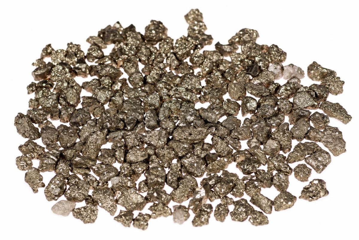 A pile of small, metallic, gold-coloured pyrite crystals on a white background.