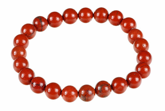 A bracelet of round red beads with dark inclusions, arranged in a circle on a white background.
