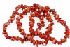 A necklace of irregular red jasper chips arranged in a loose coil on a white surface.