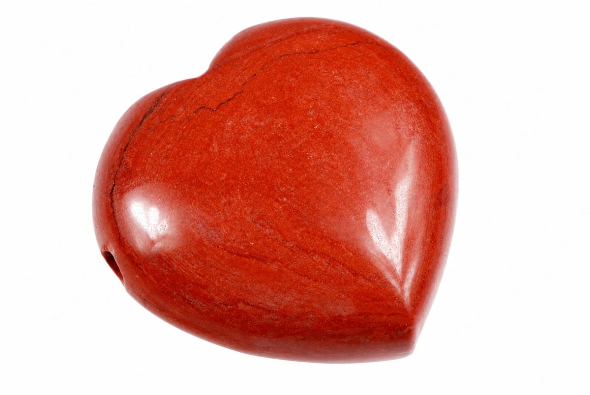 A polished red jasper heart-shaped pendant with a drilled hole on the left side, set against a white background.