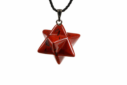 A red jasper pendant shaped like a star, hanging from a black cord against a white background.