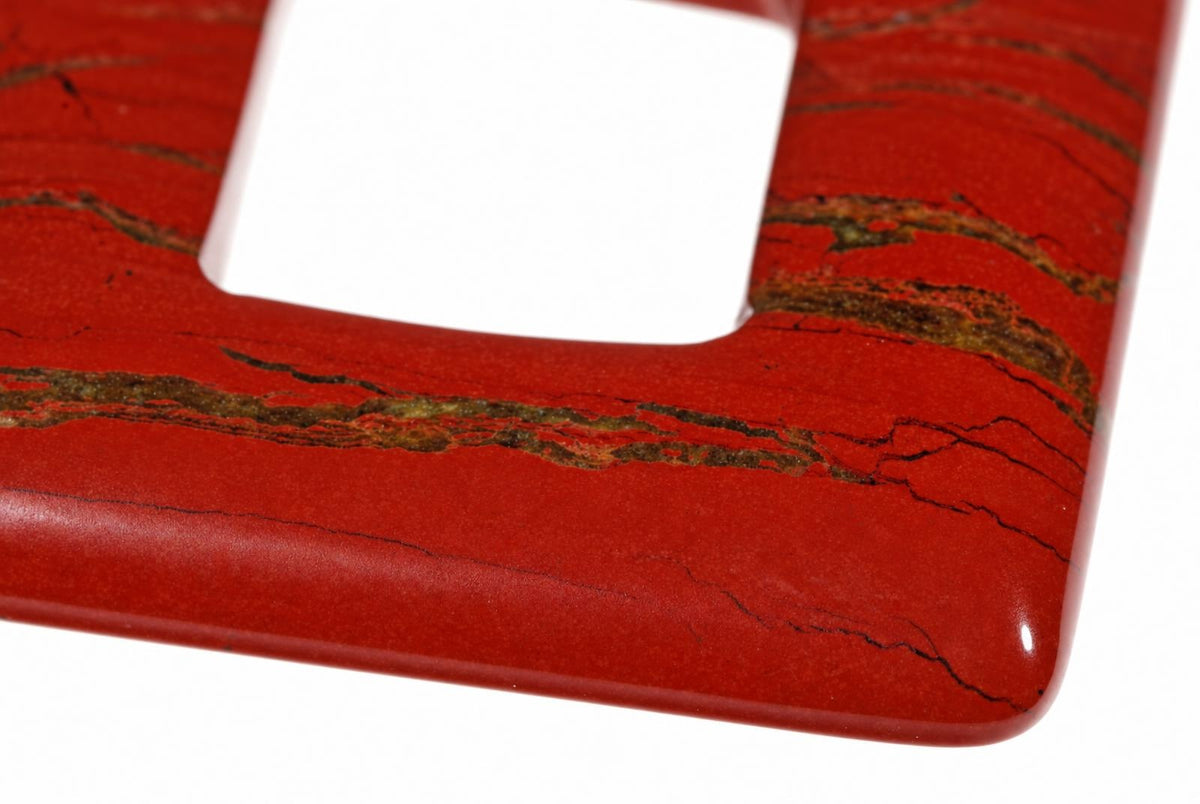 A close-up of a red jasper pendant with dark veins, featuring a square cutout on a white background.