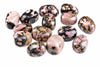 A group of polished rhodonite stones with pink, black and brown patterns on a white background.