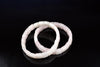 Two square rose quartz bracelets on a dark surface.