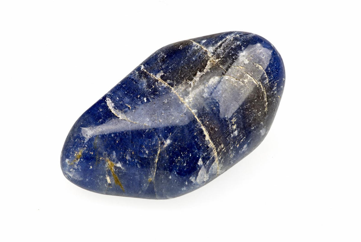 A smooth deep blue oval stone with broad grey patches and fine pale veins rests on a white surface.
