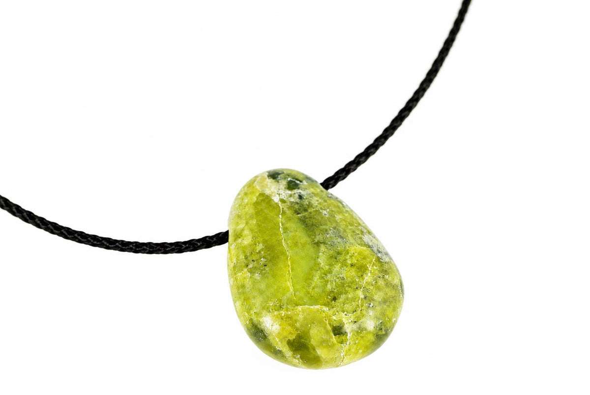 A green, teardrop-shaped pendant with a smooth surface hangs from a black cord against a white background.