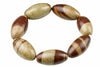 A bracelet with oval beads in dark brown and beige tones, arranged on a pale surface.