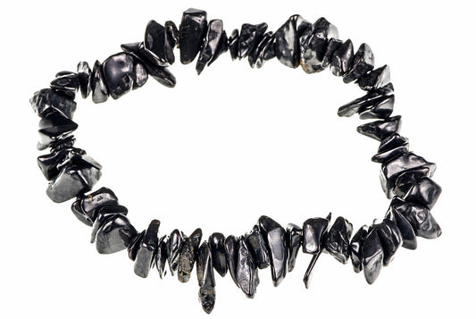 A bracelet made of irregular black and silver-toned chips arranged in a circle on a white background.