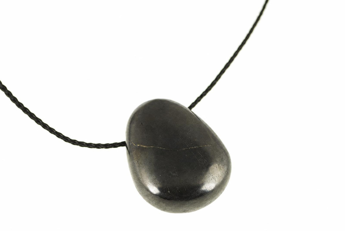 A dark, smooth, teardrop-shaped pendant on a black cord against a white background.