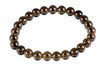 A bracelet of round, dark brown beads with a white background.