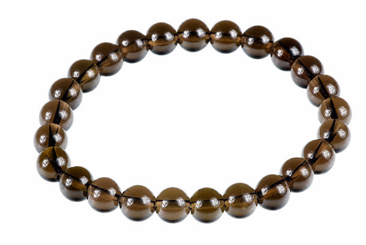 A bracelet of round, dark brown beads with a white background.
