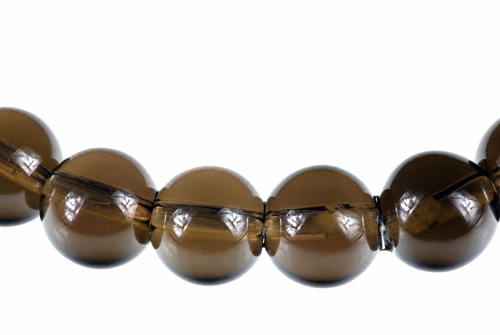A row of round, dark brown smoke quartz beads with visible internal inclusions on a white background.