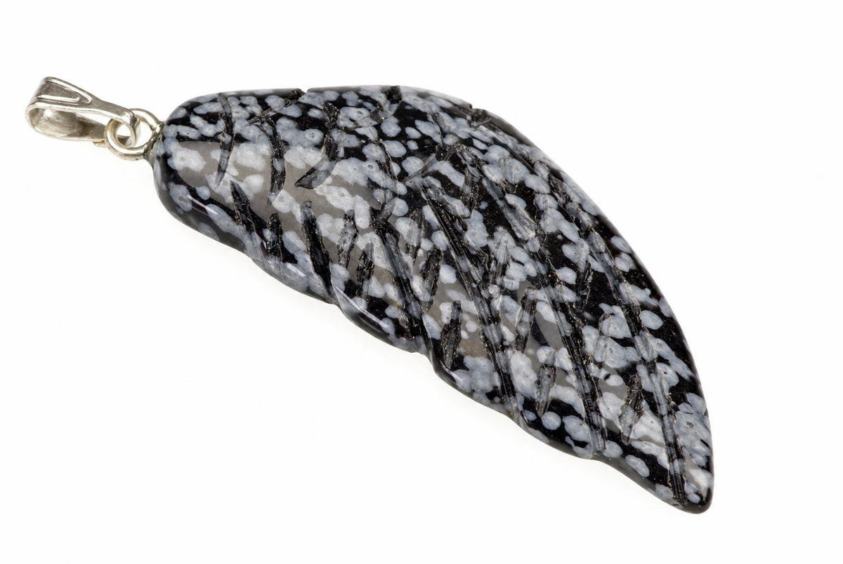 A silver-toned pendant with a polished, wing-shaped stone featuring black and white speckled patterns on a pale surface.