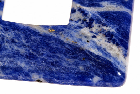 A polished sodalite pendant with deep blue and white swirled patterns, set against a plain white background.