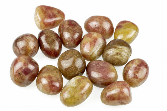 Twelve polished tumbled stones with red, brown and yellow patterns on a white surface.