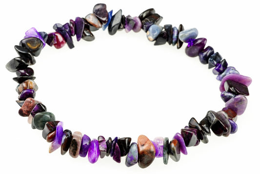 A bracelet made of polished, irregular chips in purple, black, blue, and brown tones arranged on a white surface.