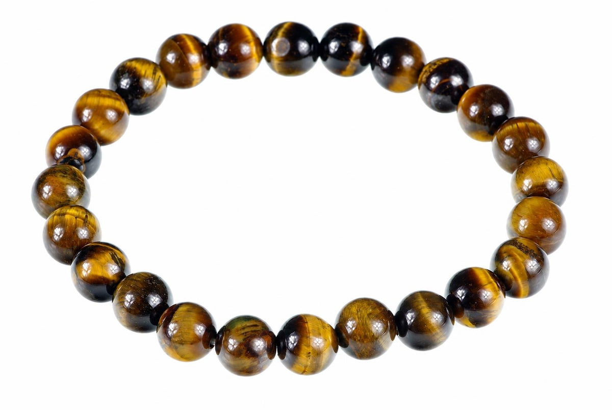 A circular bracelet of glossy round golden-brown beads with dark bands rests on a white background.