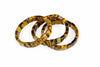 Three square tiger eye bracelets with yellow and brown stripes lie on a white surface.