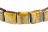 A bracelet with square beads of polished tiger eye stone, showing yellow and brown stripes on a white background.