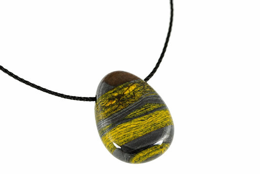 A polished oval pendant with dark brown, black and yellow striped bands hangs from a black cord against a white background.