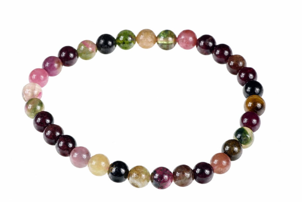 A circular bracelet combines glossy round beads in pink, green, pale yellow, brown and nearly black tones.