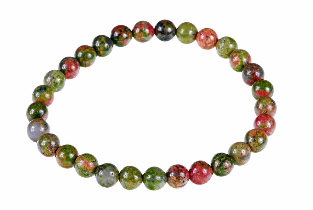 A bracelet of round beads in red, green and dark tones on a white background.